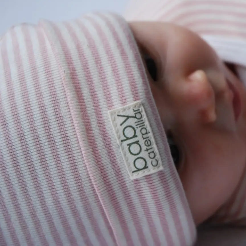 pink stripe beanie close up on baby