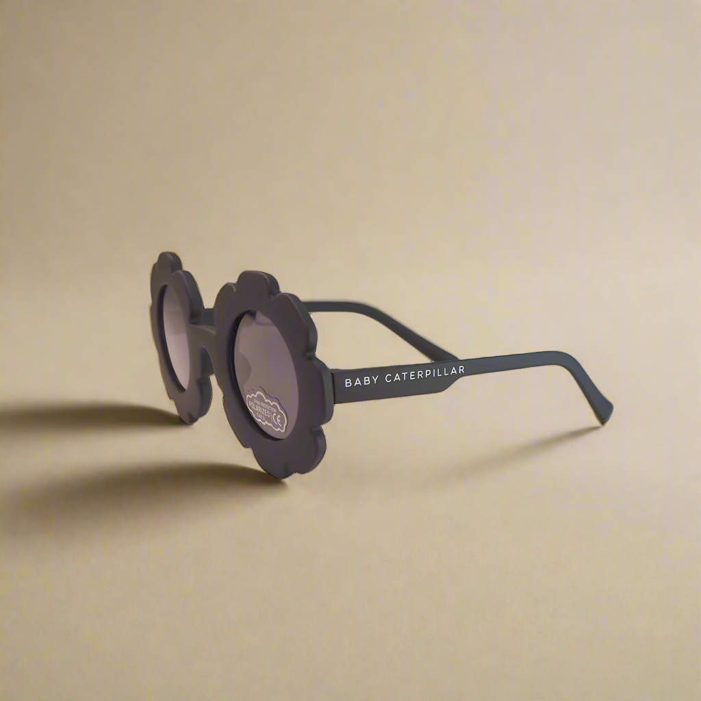 Black sunglasses with 'Baby Caterpillar' branding on a white background
